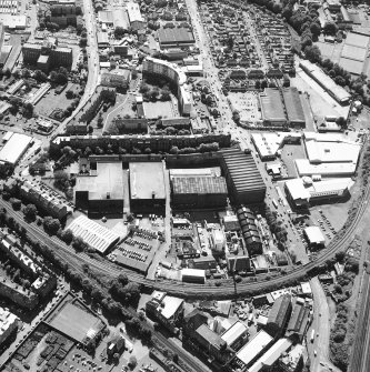 Oblique aerial view centred on the bonded warehouse with the park and bowling green adjacent, taken from the NE.