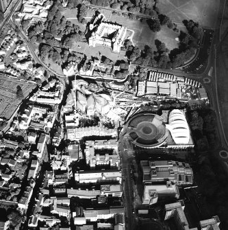 Oblique aerial view centred on the construction of the Scottish Parliament with the exhibition centre and palace adjacent, taken from the WSW.