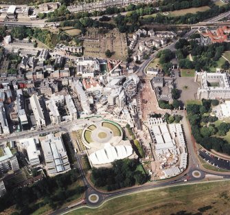 Oblique aerial view centred on the construction of the Scottish Parliament with Our Dynamic Earth and Queensbury House adjacent, taken from the S.