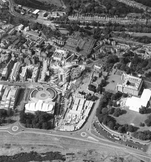 Oblique aerial view centred on the construction of the Scottish Parliament with Our Dynamic Earth, Queensbury House and Holyrood Palace adjacent, taken from the S.