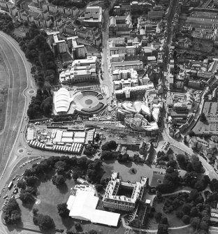 Oblique aerial view centred on the construction of the Scottish Parliament with Our Dynamic Earth, Queensbury House and Holyrood Palace adjacent, taken from the E.