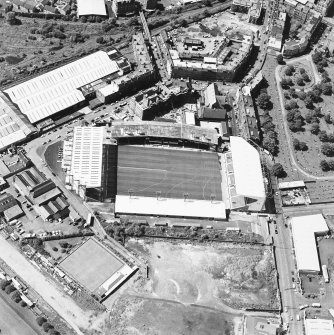 Oblique aerial view of Easter Road Stadium, Hibernian Football Club, taken from the NE, centered on the stadium.