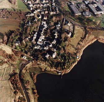 Oblique aerial view of Edinburgh centred on Duddingston Village with the parish church and south lodge visible, taken from the WSW.