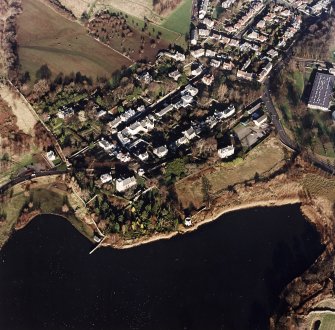 Oblique aerial view of Edinburgh centred on Duddingston Village with the parish church and south lodge visible, taken from the SW.