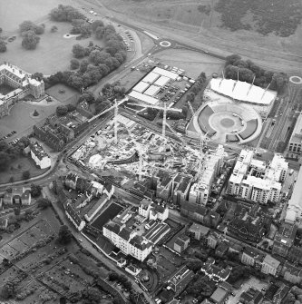 Oblique aerial view centred on the construction of the Scottish Parliament with the
exhibition centre adjacent, taken from the NW.
