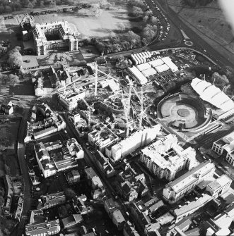 Oblique aerial view centred on the construction of the Scottish Parliament, with `Our Dynamic Earth', Queensberry House and Holyrood Palace adjacent, taken from the W.
