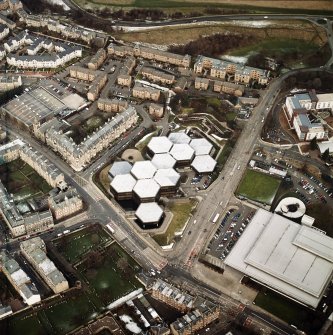 Oblique aerial view centred on the offices with the swimming pool, school, burial ground and church adjacent, taken from the SW.