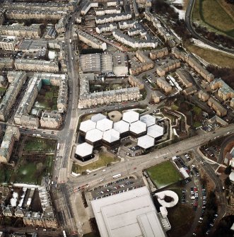 Oblique aerial view centred on the offices with the school, burial ground and church adjacent, taken from the SE.