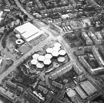 Oblique aerial view centred on the offices with the swimming pool, school, burial ground and church adjacent, taken from the NNW.