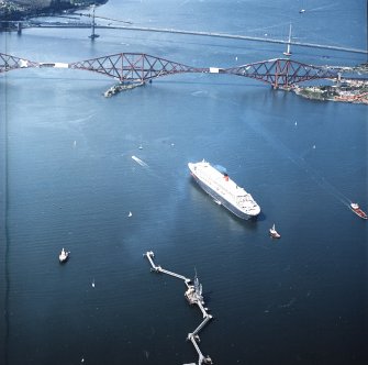 Oblique aerial view centred on the Queen Mary II cruise liner with road bridge and rail bridge adjacent, taken from the ENE.