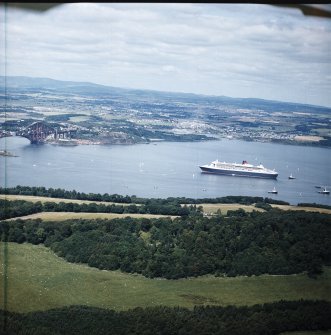 General oblique aerial view of the Queen Mary II cruise liner with rail bridge adjacent and Fife beyond, taken from the SE.