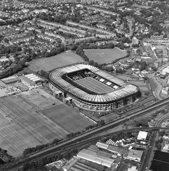 Edinburgh, Murrayfield Stadium, oblique aerial view, taken from the SSW, centred on Murrayfield Stadium. Murrayfield Ice Rink and Roseburn House are visible in the centre of the photograph.