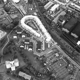 Oblique aerial view centred on Slateford Green with brewery adjacent, taken from the SW.