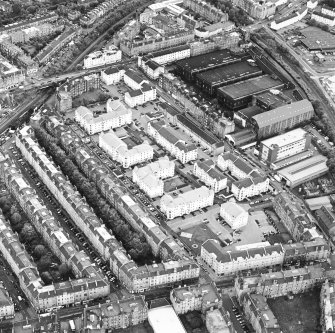 Oblique aerial view centred on Sinclair Place with bakery, factory and brewery adjacent, taken from the N.