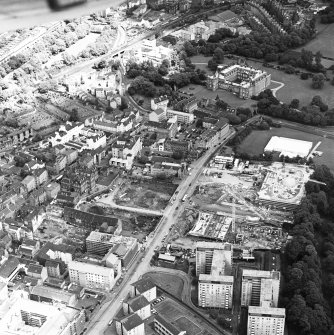 Oblique aerial view of Edinburgh centred on both 'Dynamic Earth' and the Scottish Parliament under construction, and a view of the Canongate, Holyrood Palace and Holyrood Abbey, taken from the SSW.