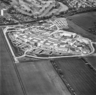 Oblique aerial view centred on the hospital, taken from the ENE.