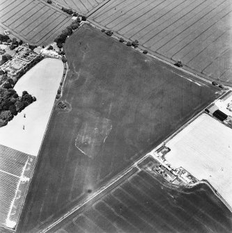 Oblique aerial view of Broomhouse taken from the SSW, centred on the cropmark of a quarry and a possible trackway, and showing Bourhouse Dovecot in the top left-hand corner of the photograph.