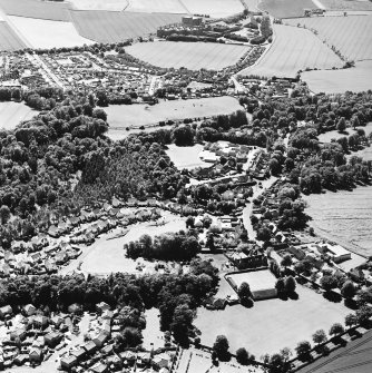 Oblique aerial view centred on the village of Easter Pencaitland with Wester Pencaitland and Maltings adjacent, taken from the NE.