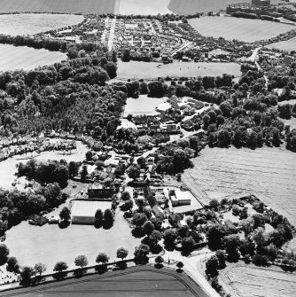 Oblique aerial view centred on the village of Easter Pencaitland with Wester Pencaitland and Maltings adjacent, taken from the NNE.