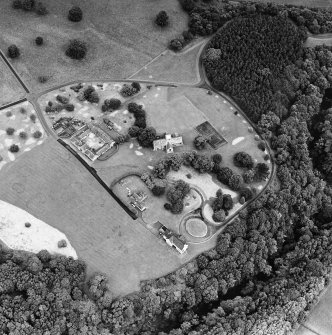 Oblique aerial view of Dunglass centred on a church and stables, taken from the S.