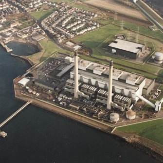Oblique aerial view of the Cockenzie Generating Station centred on the power station with a harbour adjacent, taken from the N.