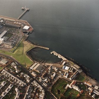 Oblique aerial view of the Cockenzie Harbour centred on the harbour with a power station adjacent, taken from the SE.