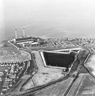 Oblique aerial view of the Cockenzie Coal Store centred on the coal store with an adjacent power station and harbour, taken from the S.