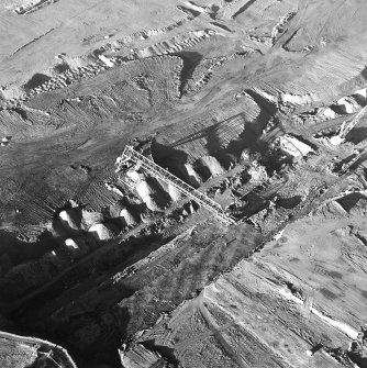 Oblique aerial view centred on the quarry, taken from the SE.