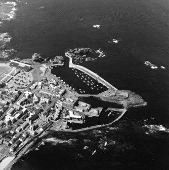 Oblique aerial view centred on the harbour with the remains of the battery adjacent, taken from the ESE.