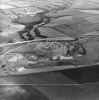 Oblique aerial view centred on the cement works and quarry, taken from the NE.