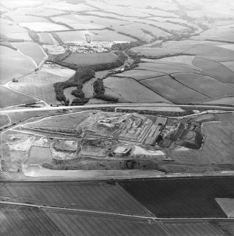 Oblique aerial view centred on the cement works and quarry, taken from the NNE.