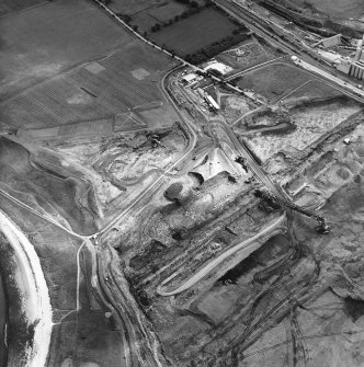 Oblique aerial view centred on the cement works and quarry with the trial excavations adjacent, taken from the NW.