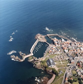 Oblique aerial view centred on the harbour with the remains of the battery adjacent, taken from the WSW.