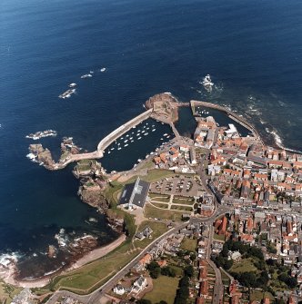 Oblique aerial view centred on the harbour with the remains of the battery adjacent, taken from the W.