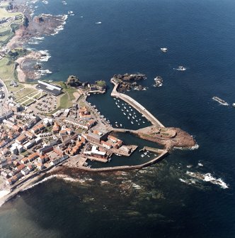 Oblique aerial view centred on the harbour with the remains of the battery adjacent, taken from the SW.