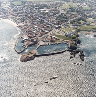 Oblique aerial view centred on the harbour with the remains of the battery adjacent, taken from the NNE.