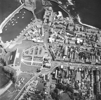 Oblique aerial view centred on the barracks with fishermen's housing at Victoria Place, harbours and leisure centre adjacent, taken from the WSW.