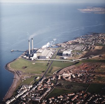 Oblique aerial view centred on the power station with town and harbours adjacent, taken from the SSW.