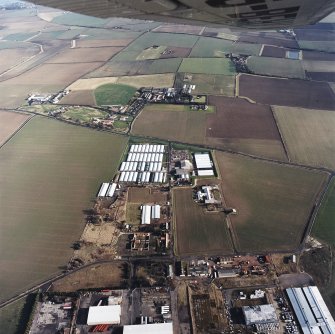 Oblique aerial view centred on the farm, buildings, farmhouse and mushroom farm with farmhouse and buildings adjacent, taken from the WSW.