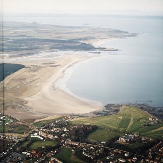 General oblique aerial view looking across the school, club house and Belhaven Bay towards North Berwick Law, the Firth of Forth and the Bass Rock, taken from the SE.