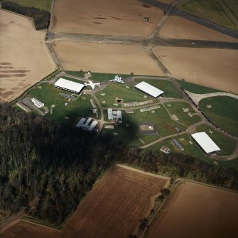 Oblique aerial view of East Fortune Airfield centred on the aircraft hangers, taken from the SSE.