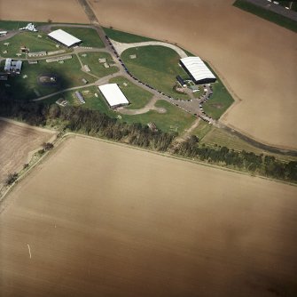 Oblique aerial view of East Fortune Airfield centred on the aircraft hangers, taken from the SSE.