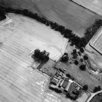 Oblique aerial view of centred on Abbeymill Farm and graveyard with the site of the nunnery adjacent.