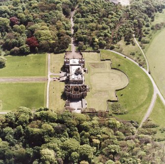 Oblique aerial view of house and formal gardens from SSE.