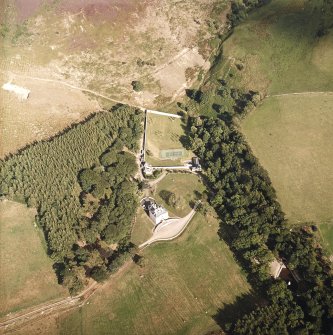 Oblique aerial view centred on the country house, cottage and walled garden, taken from the WNW.