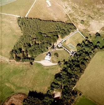 Oblique aerial view centred on the country house, cottage and walled garden, taken from the WSW.