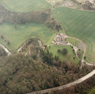 Oblique aerial view of Dalhousie Castle and estate bridge, taken from ENE.