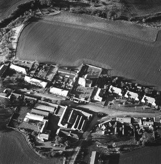 Oblique aerial view of Carrington Parish Church centred on a church with a general view of the burgh, taken from the SE.