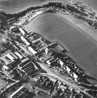 Oblique aerial view of Carrington Parish Church centred on a church with a general view of the burgh, taken from the E.