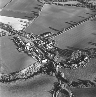 Oblique aerial view of Carrington, General centred on the burgh with an adjacdent church, taken from the W.